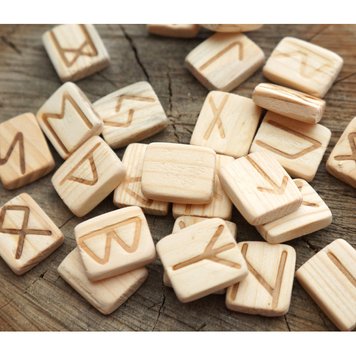 A set of wooden runes for divination with annotation Acacia